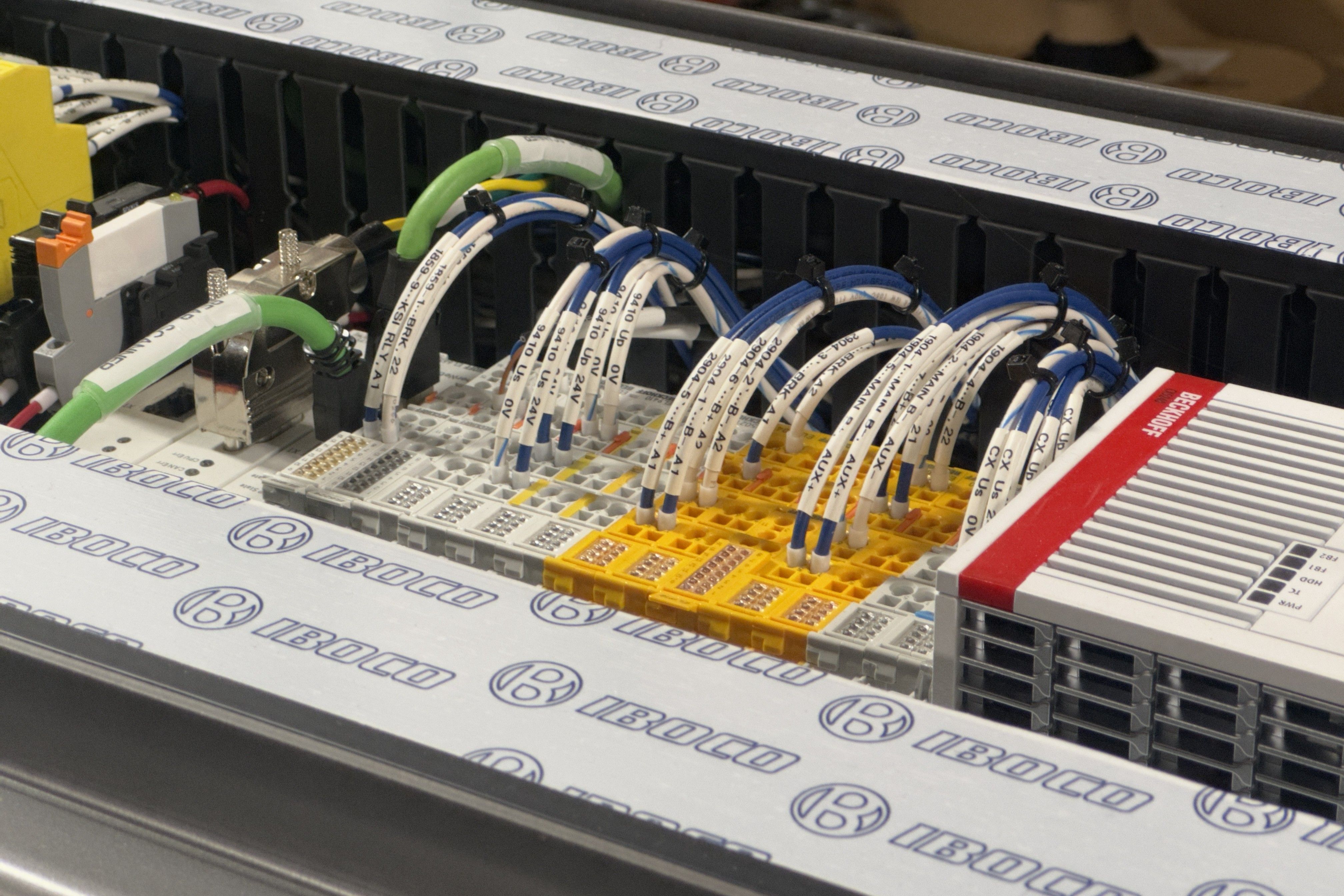 Beckhoff PLC I/O terminals in a control cabinet, wired with numbered and labelled conductors dressed into wire duct